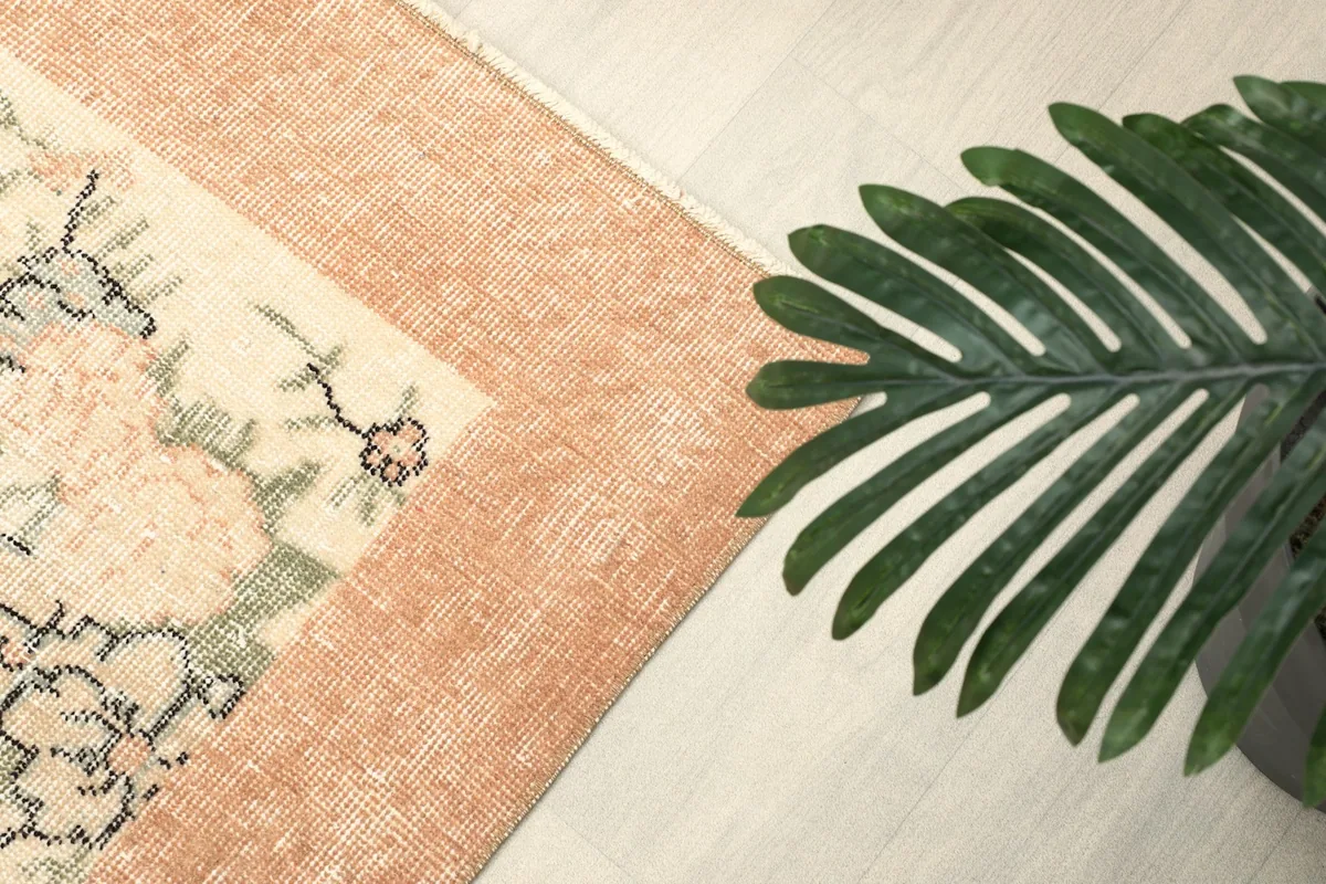 Close-up of the rust-colored border and a corner of the cream field with floral elements