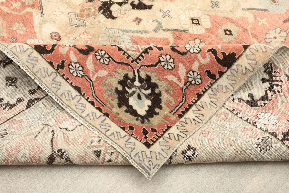 View of the rug folded to show the pile density and colors from an elevated angle