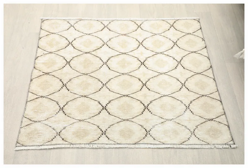 Full overhead view of the vintage ivory and charcoal geometric Anatolian rug