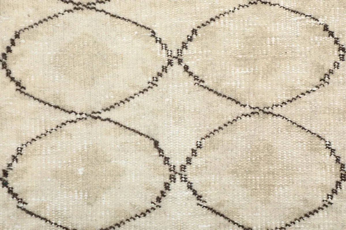 Detailed view of the interlocking geometric motifs and subtle color variations