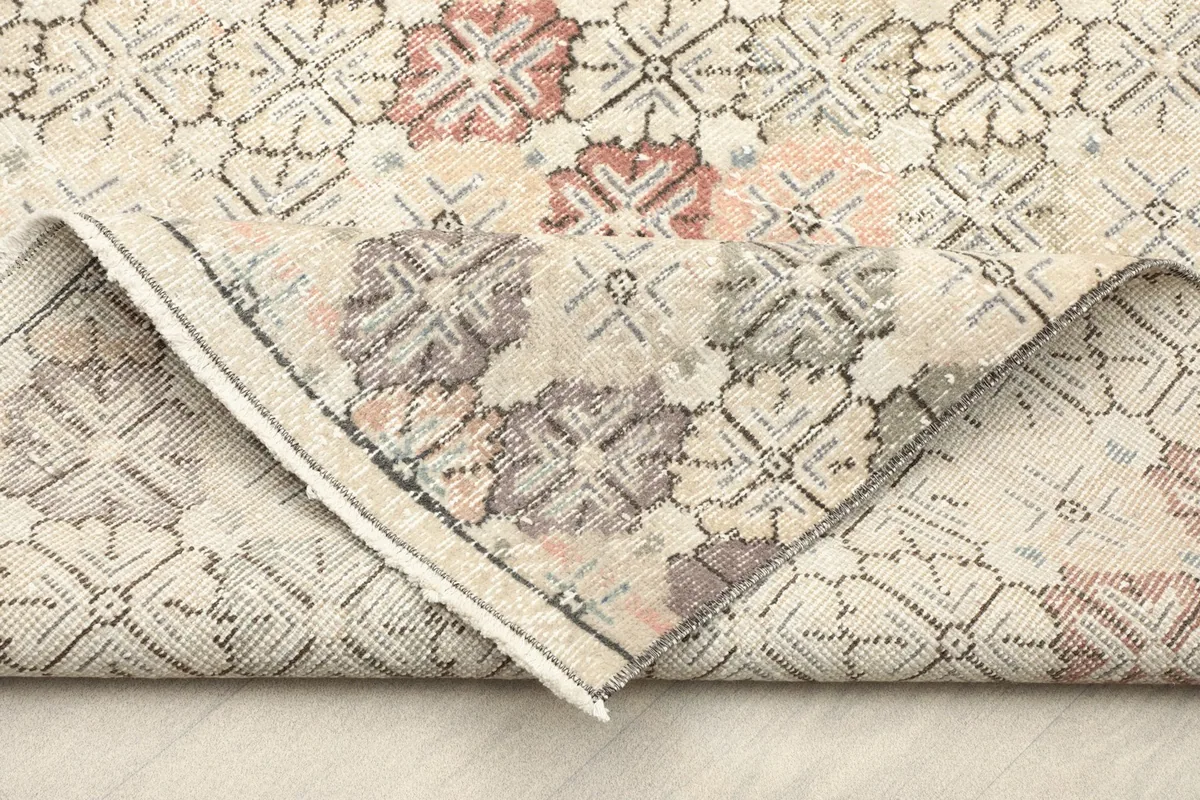 Folded section of the rug, revealing the wool pile and cotton foundation