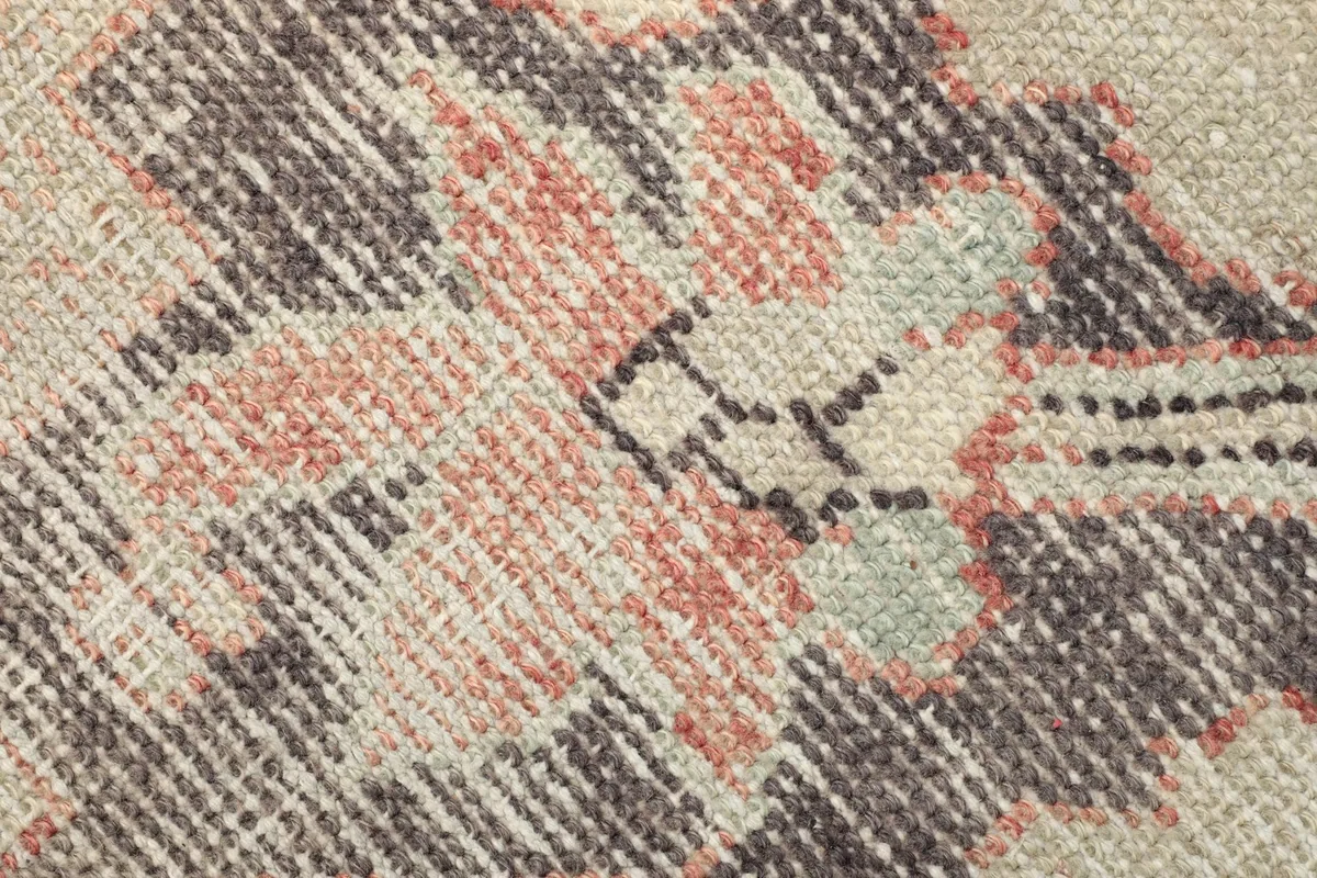 Texture detail of the low wool pile and hand-knotted construction with various colors