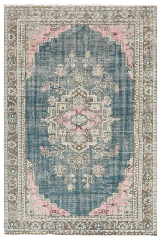 Full top view of the 6'8" x 10'4" blue and rose vintage Anatolian rug on a white background.