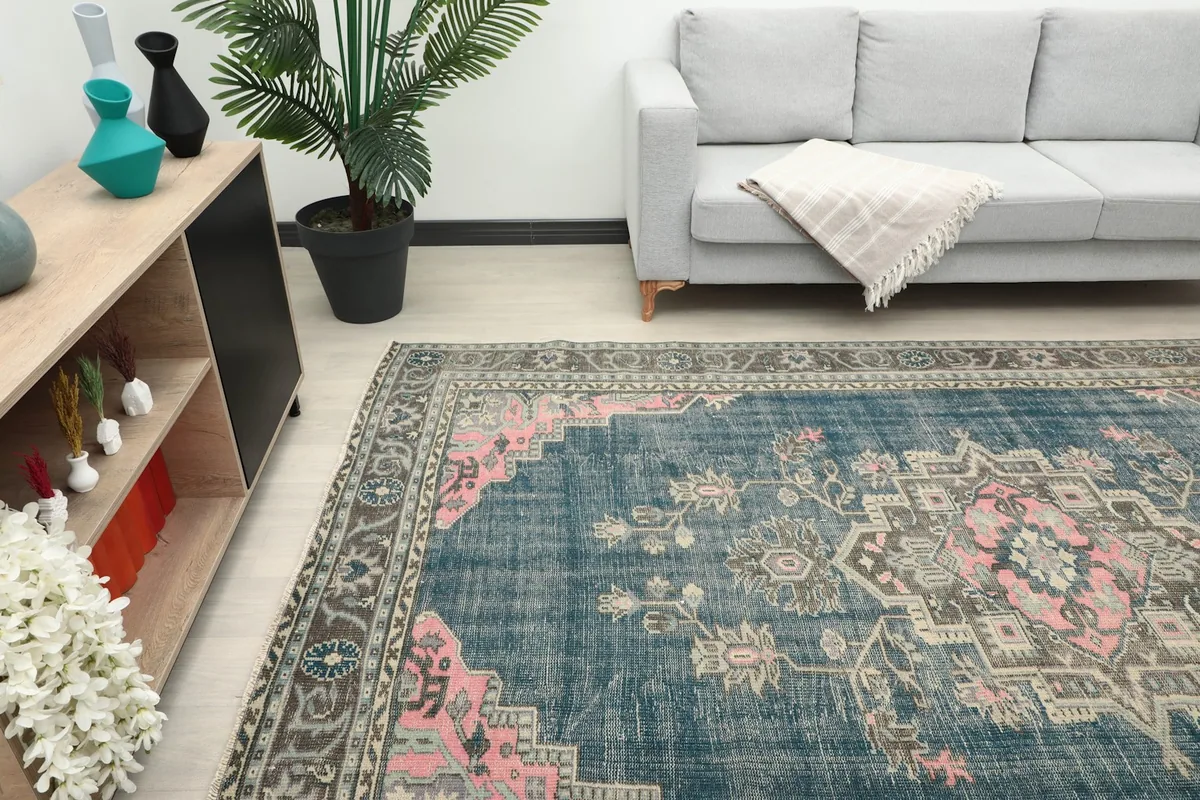Overhead angle of the vintage rug in a living space, highlighting its placement and scale.