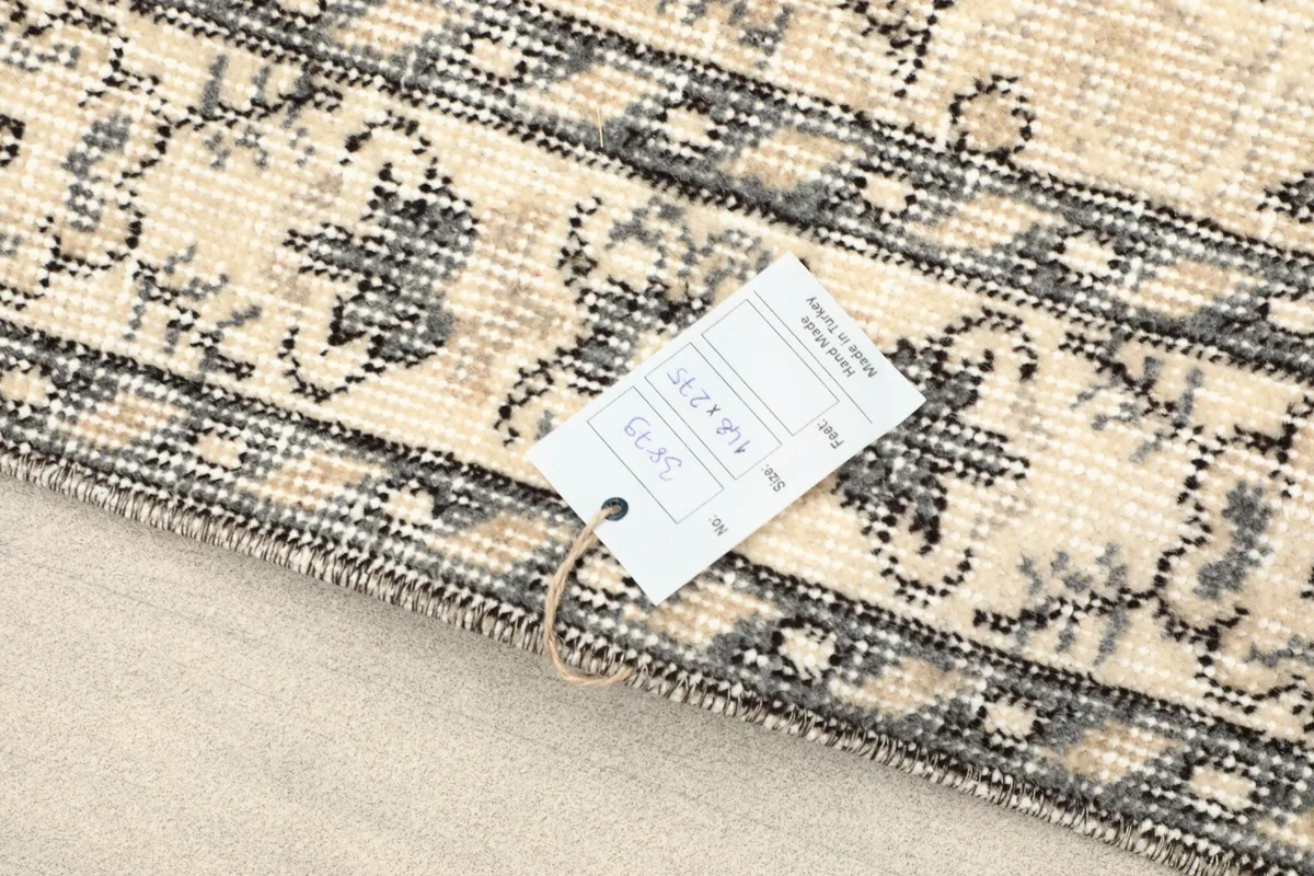 Rug tag displaying size and material details attached to the rug