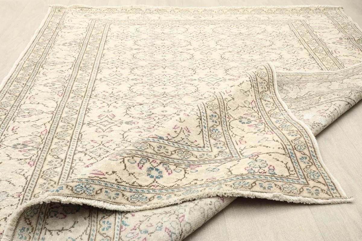 Close-up of the low pile texture and intricate patterns on the surface of the rug