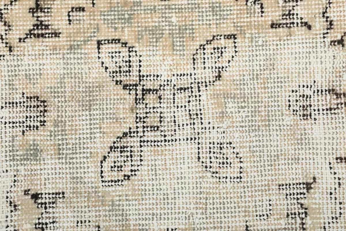 Extreme close-up showing the low pile and intricate knotting of the wool fibers.