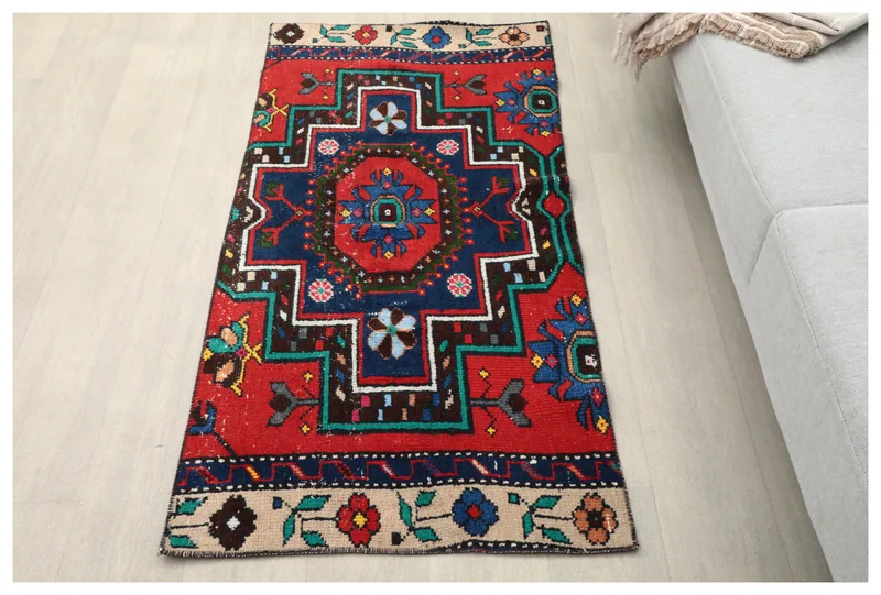 Full top view of the vintage Anatolian rug with red and navy geometric patterns on a white background.