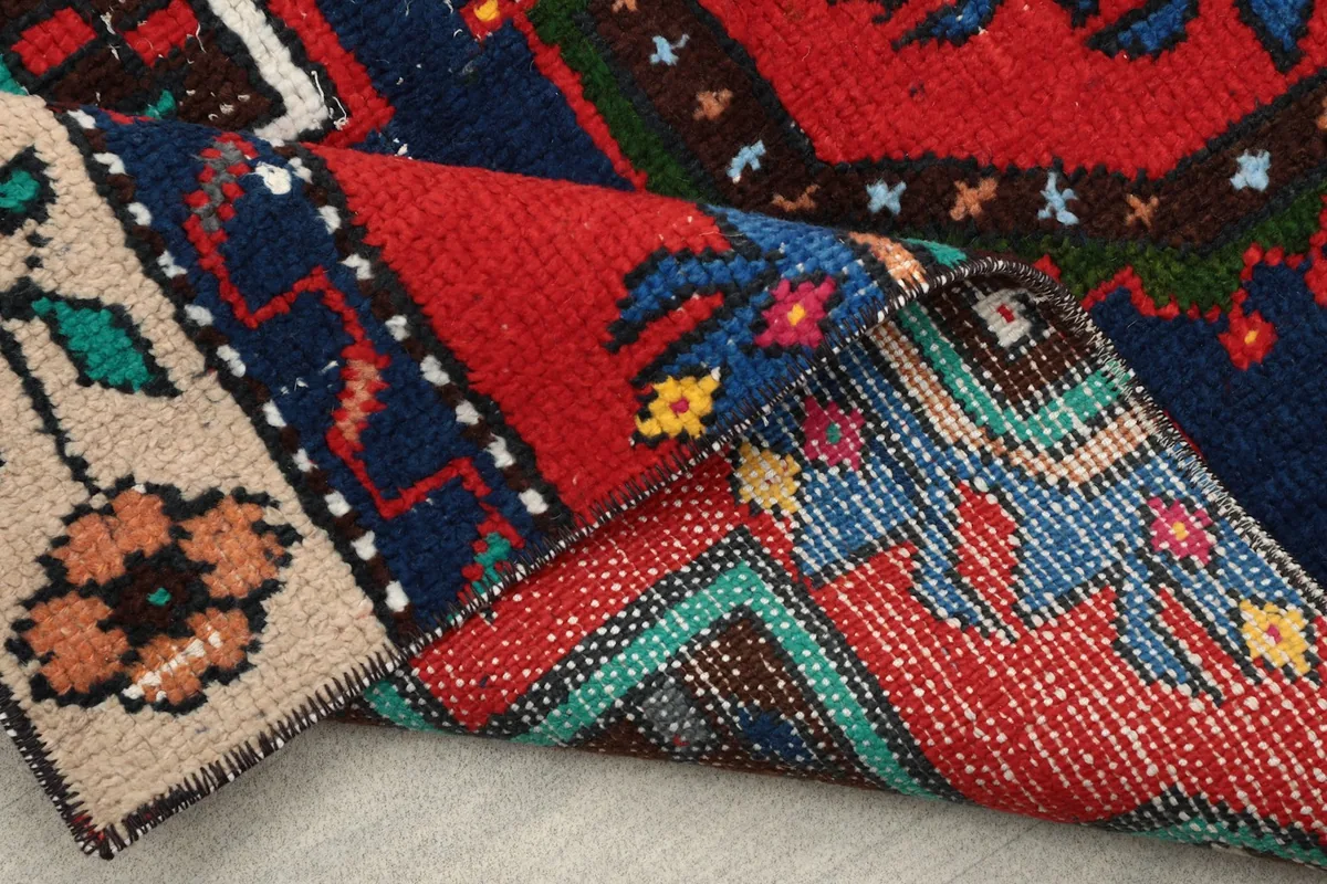 Another view of the rug folded, highlighting the craftsmanship and the colors from different angles.
