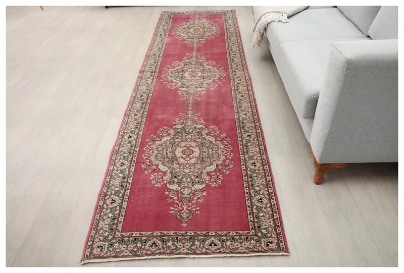 Full overhead view of the 2'11" x 10'5" rose Anatolian runner rug with medallion motifs