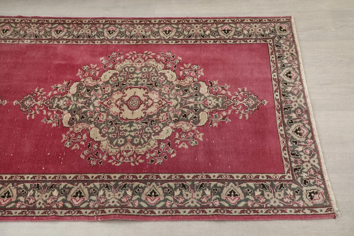 Close-up view of a rose field medallion motif and border design on the runner