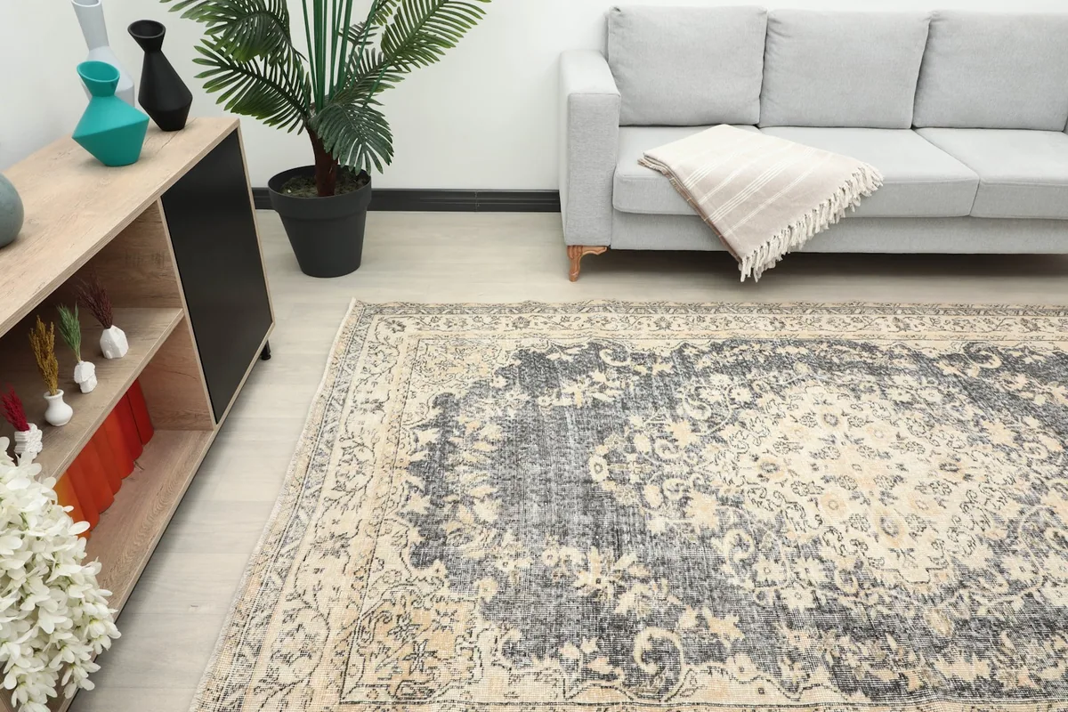 Rug in a room setting, showcasing its charcoal and beige colors and overall size