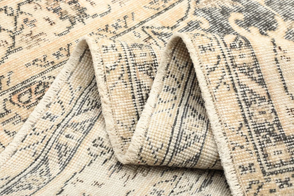 Folded section of the vintage rug showing its flexibility and construction