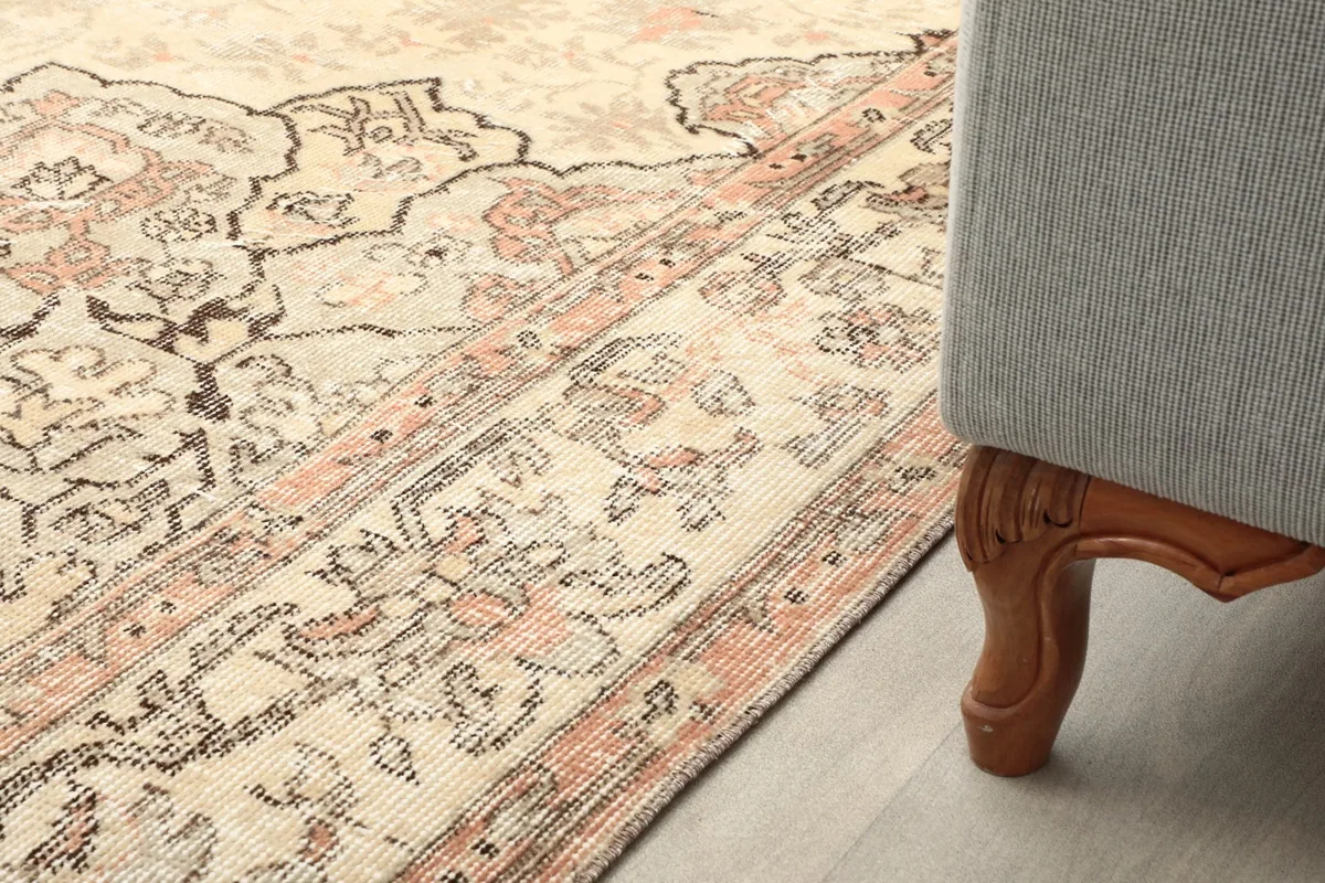 Rug placed next to a sofa leg, showing how it fits into a home decor setting