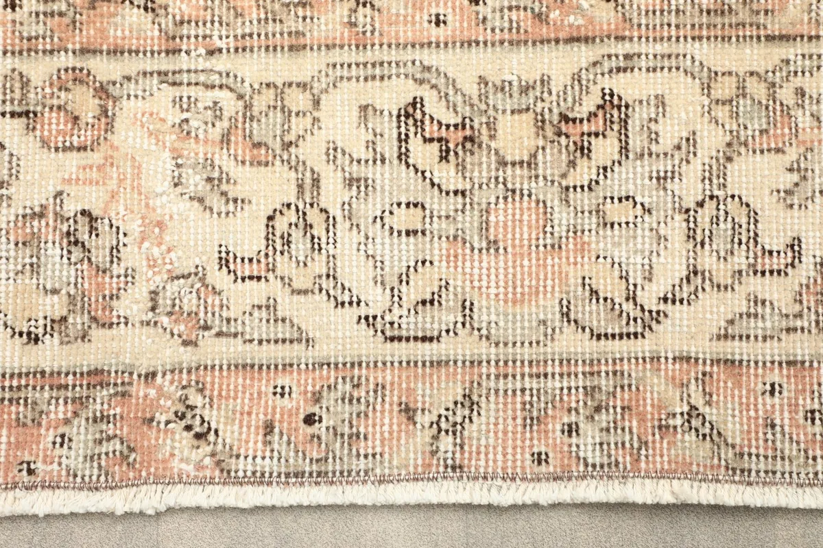 Close-up detail of the rug's border pattern and fringe