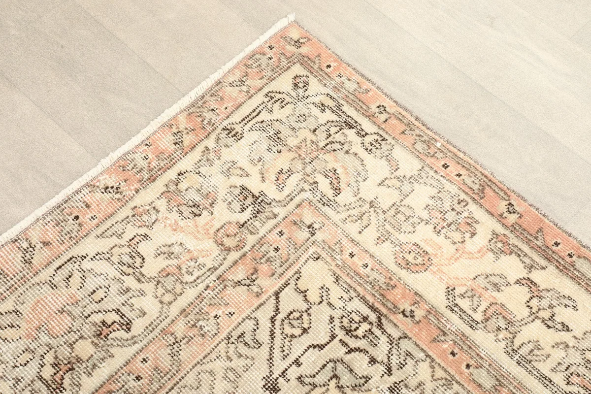 Corner detail of the rug showing the intricate rose and ivory border
