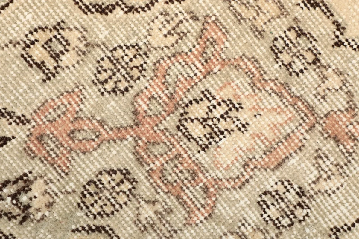 Close-up of the hand-knotted wool pile showing texture and color variations