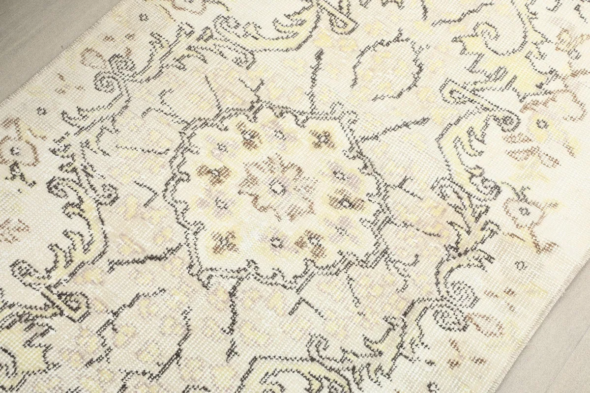 Detailed view of the central medallion design on the ivory field