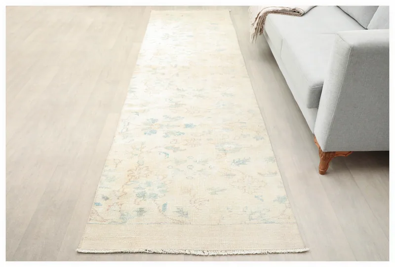 Full overhead view of the 2'11" x 10'5" cream vintage Anatolian runner rug on a white background.