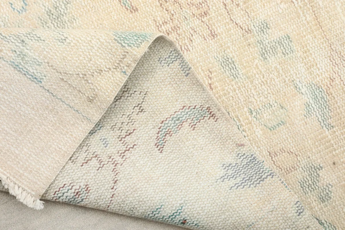 Folded section of the runner rug, revealing the sturdy cotton foundation and the back of the wool pile.