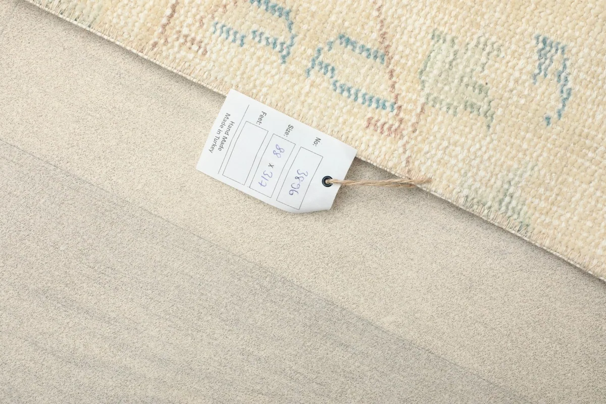 Close-up of the rug's label, displaying the size 2'11" x 10'5" and origin details.