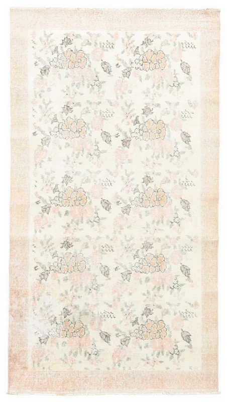 Full overhead view of the 4x7 ivory vintage Anatolian rug with rose and orange floral pattern.
