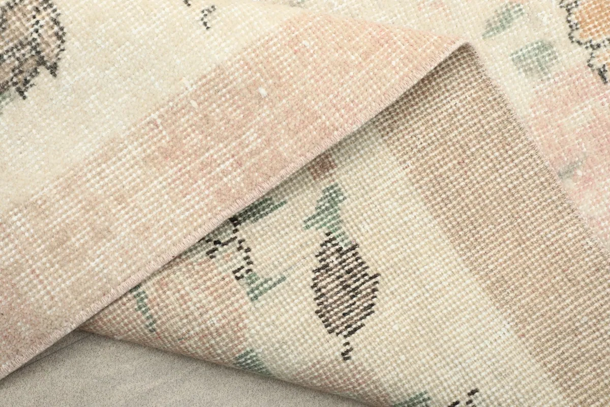 Close-up of the back of the rug, illustrating the tight hand-knotted construction and foundation.