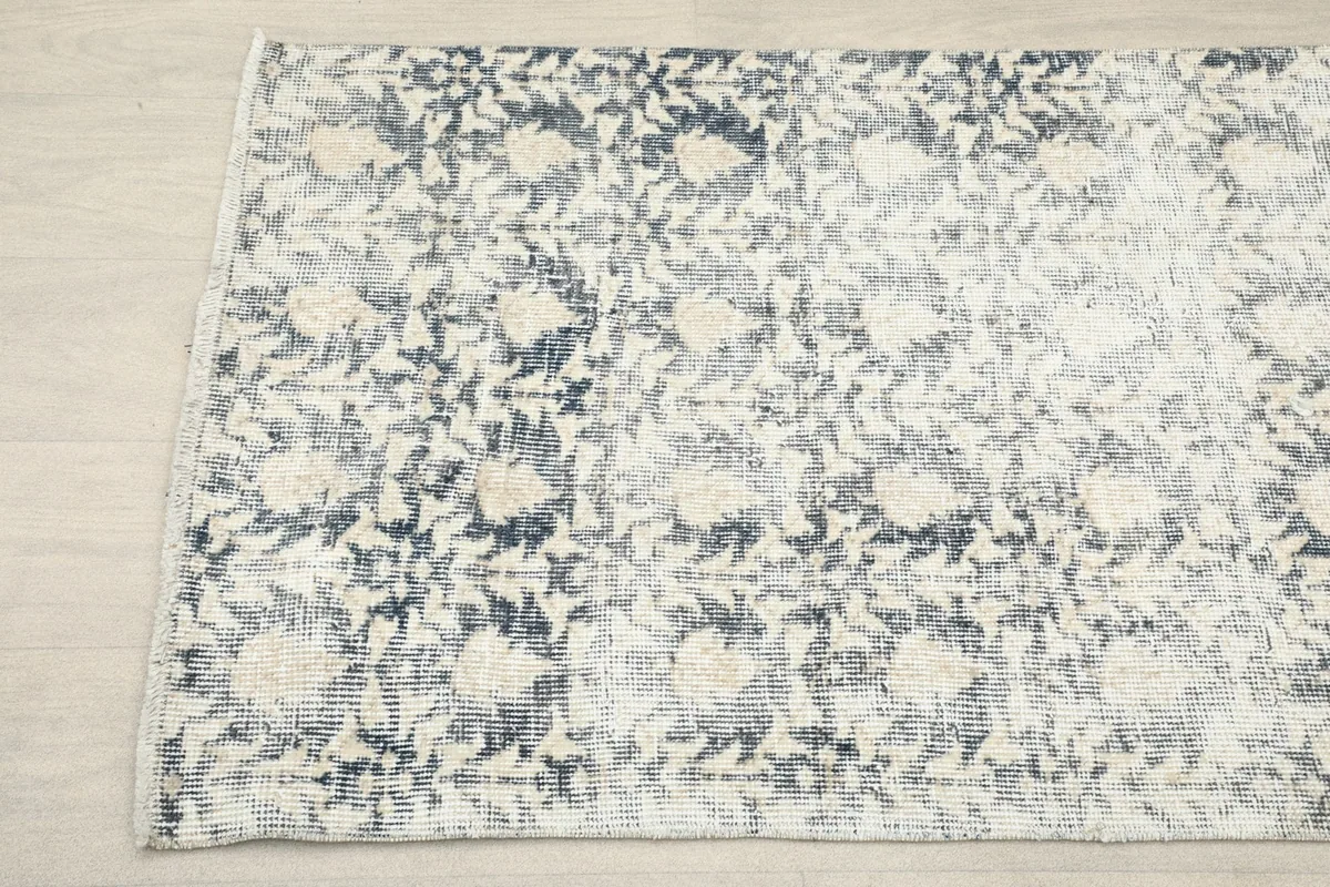 Another close-up of the runner rug's pattern, showing the faded colors and texture.