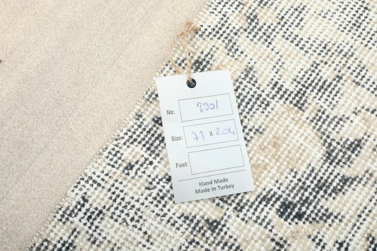 Handmade in Turkey tag with rug dimensions attached to the back of the vintage runner rug.