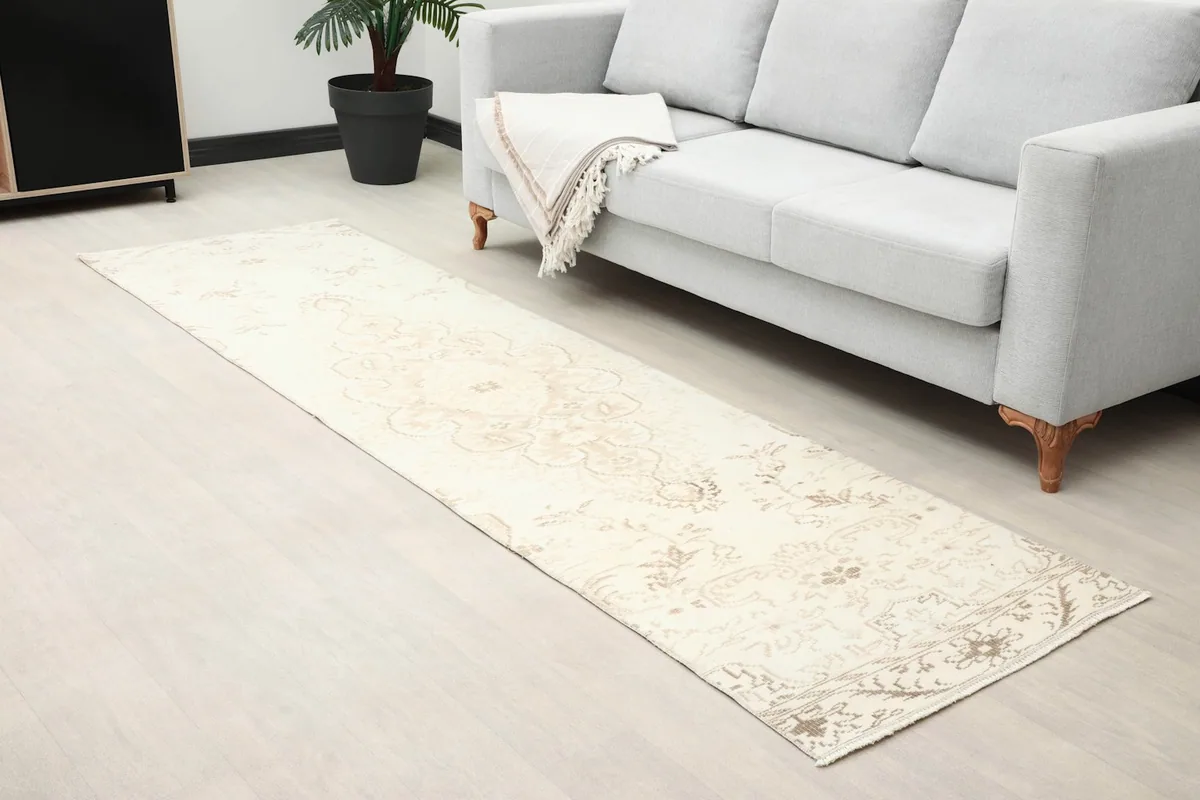 Runner rug placed along a sofa, highlighting its length and design