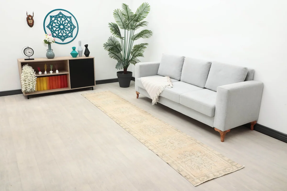Long view of the beige runner in a living space, showing its full length and subtle pattern