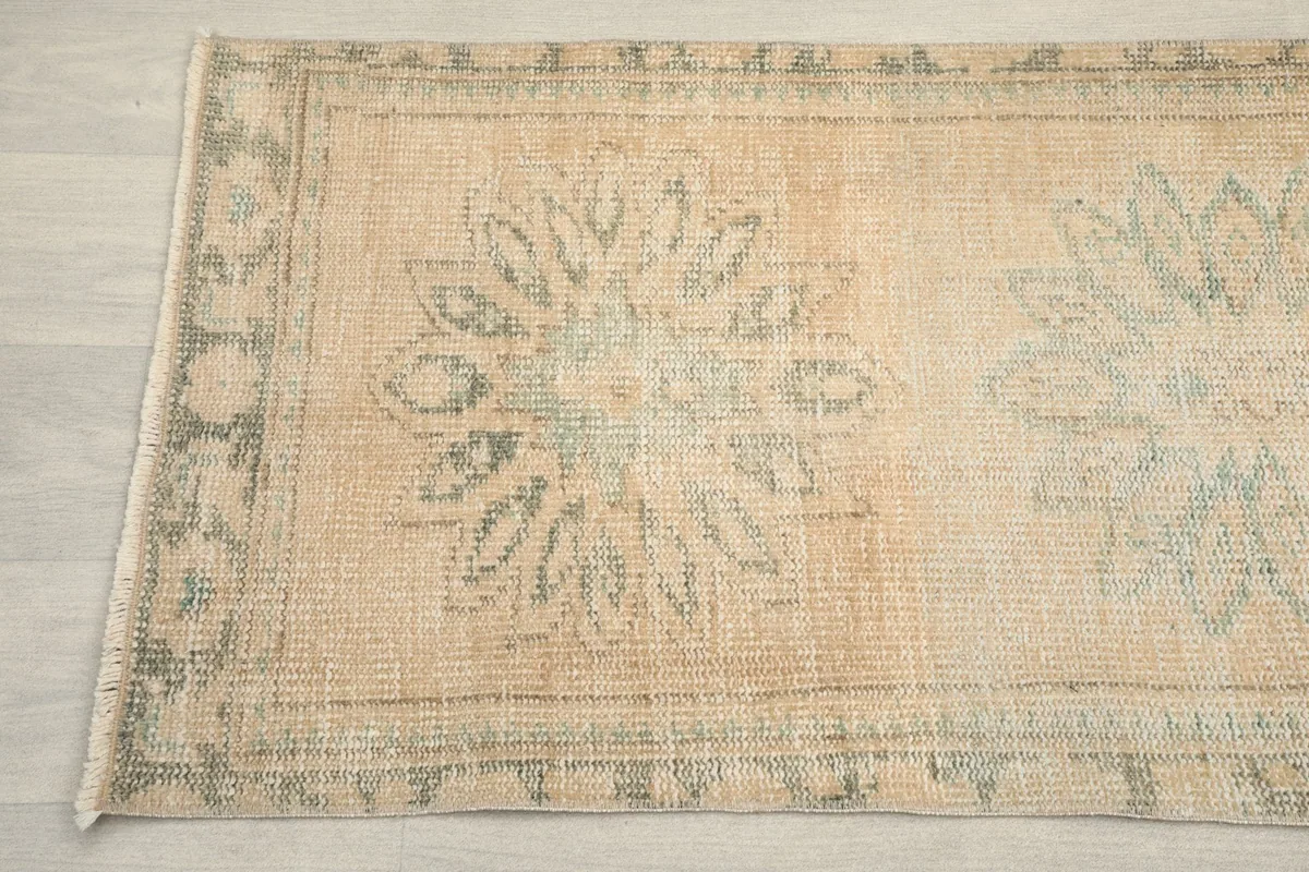 Detailed view of the runner's border and a central floral motif, showcasing the hand-knotted wool texture
