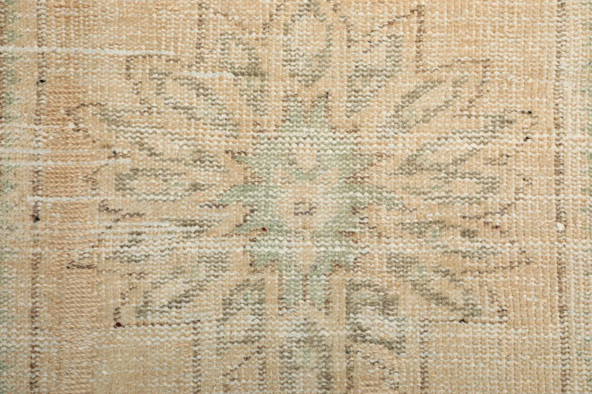 Extreme close-up of the low wool pile and the intricate knotting of the vintage runner