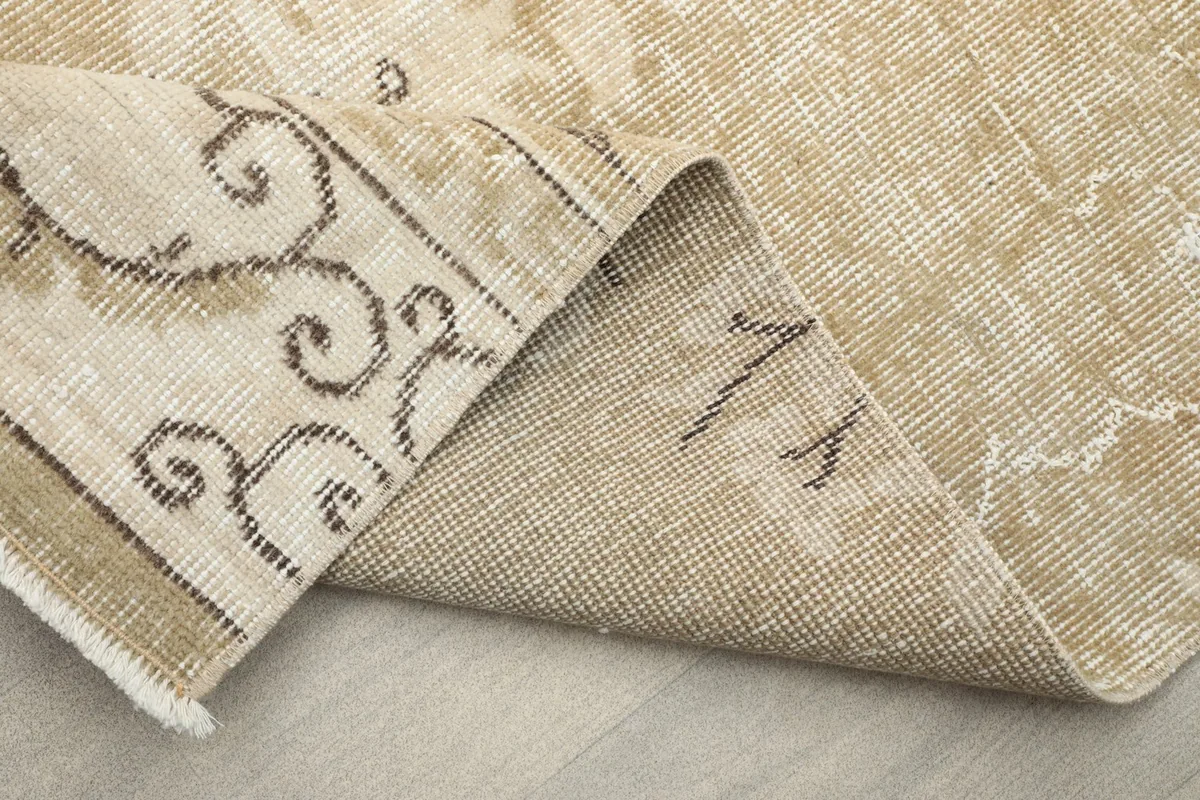 Another perspective of the rug's underside, displaying the tight knotting and wool material.