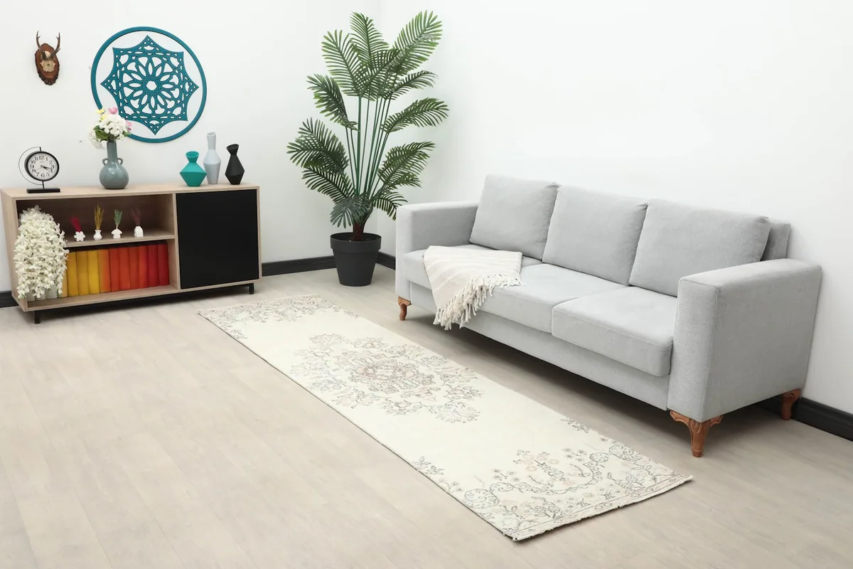 Long view of the ivory runner rug in a living space with a sofa and console table