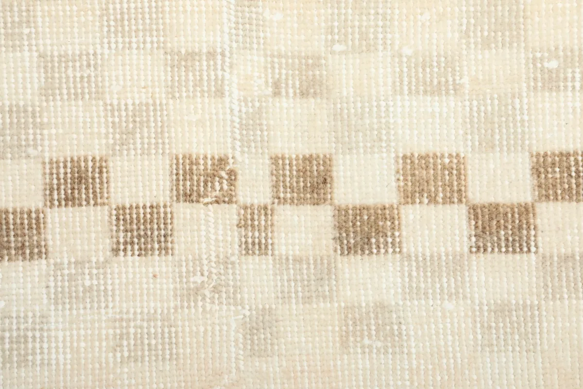 Close-up of the low wool pile and intricate knotting of the geometric design