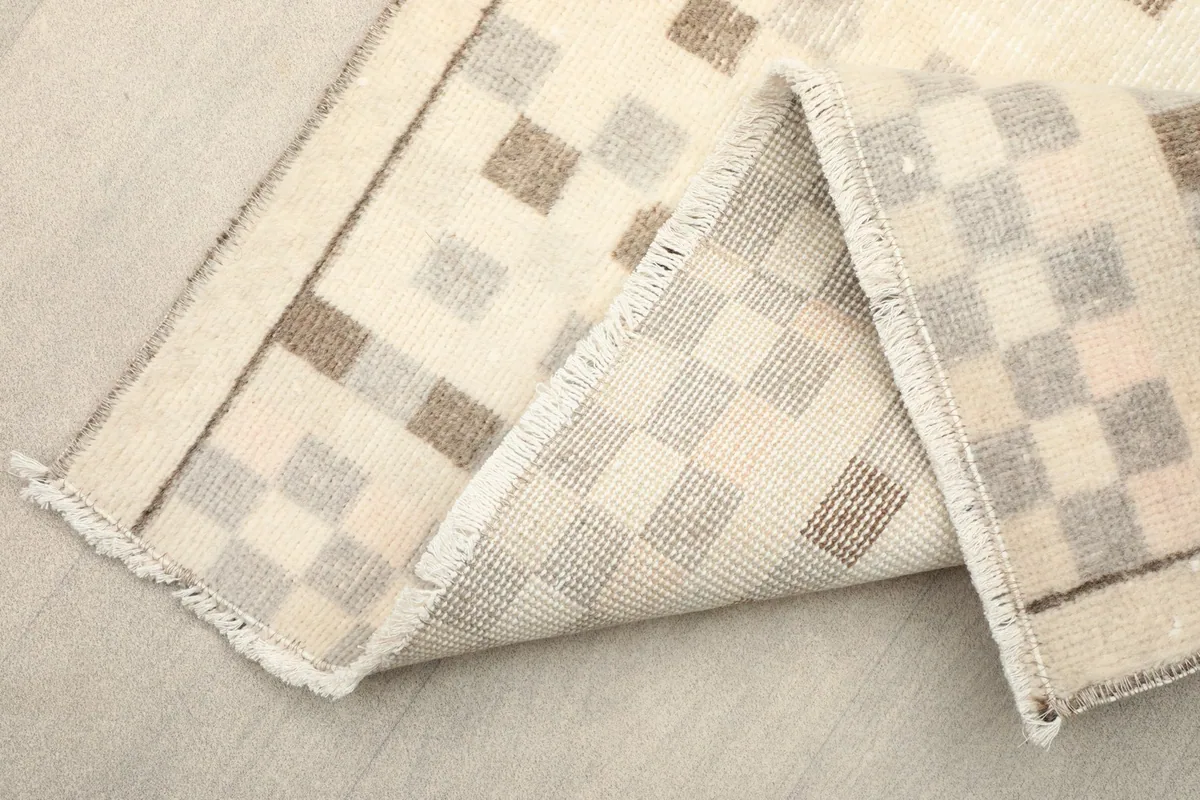 Folded section of the runner revealing the dense wool pile and cotton foundation