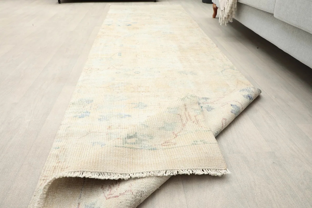 Rug partially folded, illustrating its flexibility and the consistent pattern from another angle.