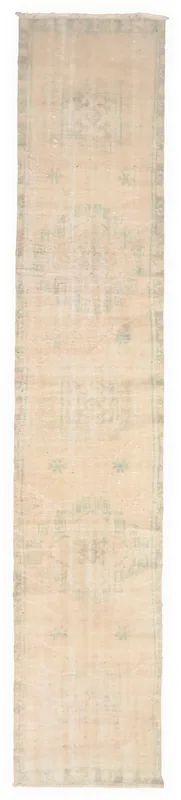 Full top view of the 2'4" x 12'1" vintage Anatolian runner rug with ivory and faded green geometric patterns.