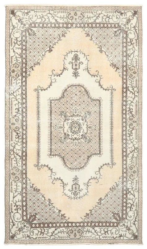 Full top view of the beige and ivory Anatolian medallion rug on a white background