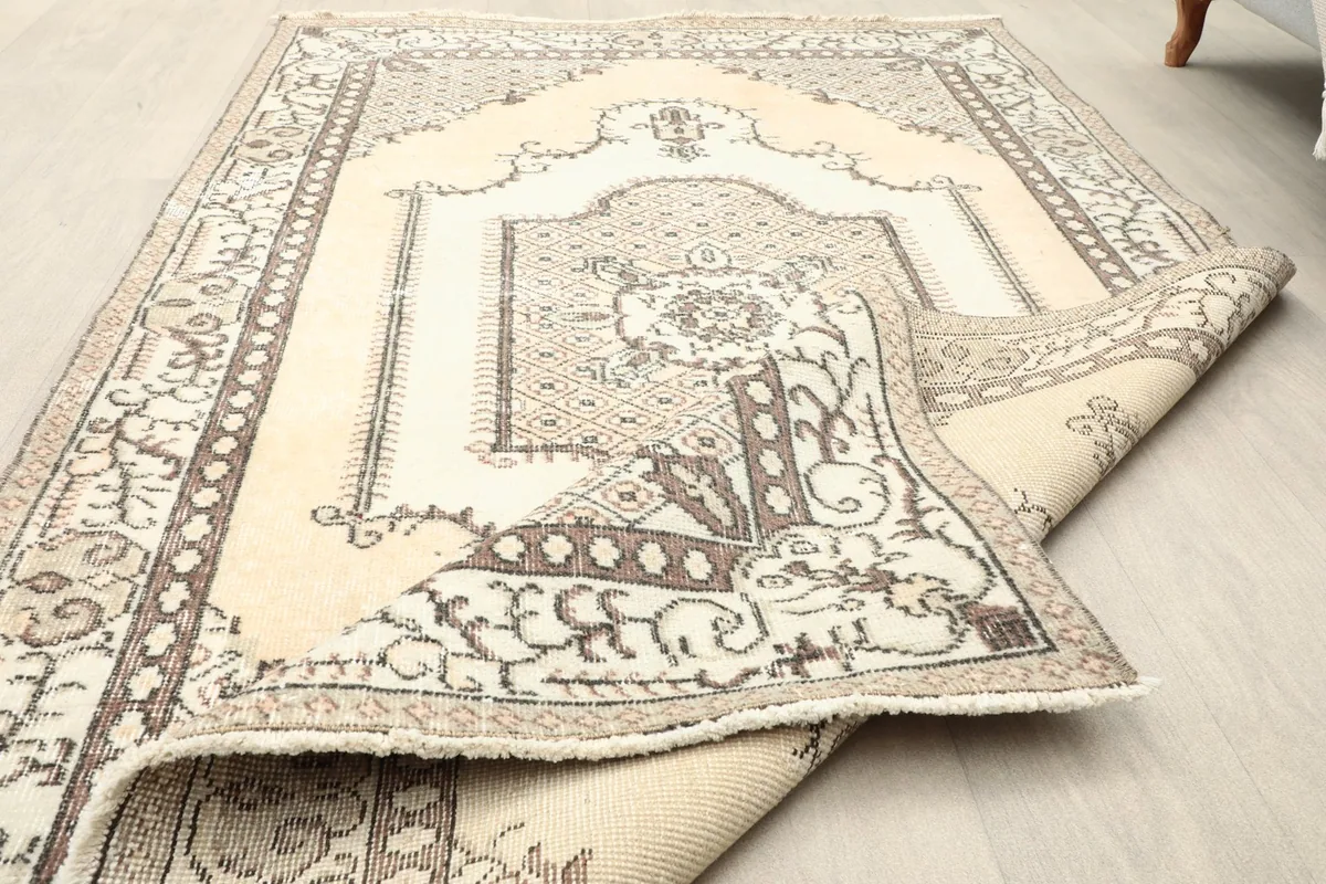 Close-up of the rug's low wool pile and the texture of the vintage material