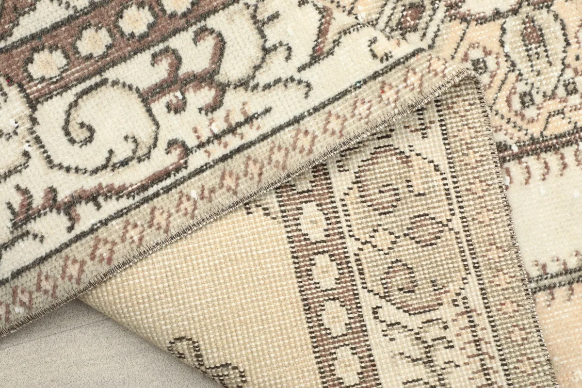 View of the rug's reverse side, revealing the tight hand-knotted construction and cotton foundation
