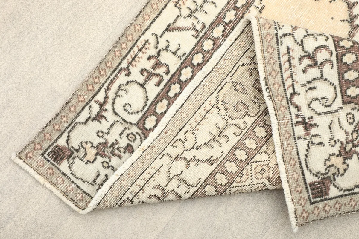 Folded section of the rug showing the back and the hand-knotted cotton foundation