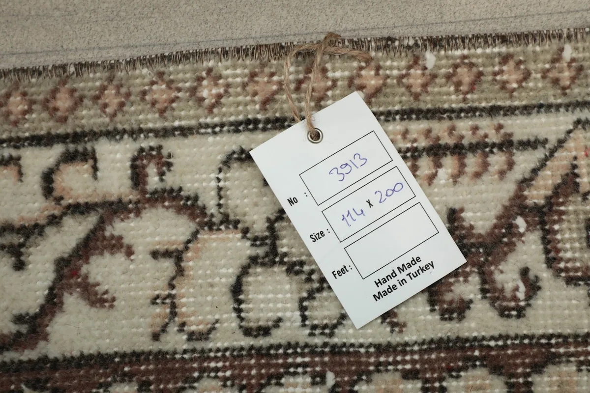Tag showing the rug's dimensions and origin, 'Hand Made in Turkey'