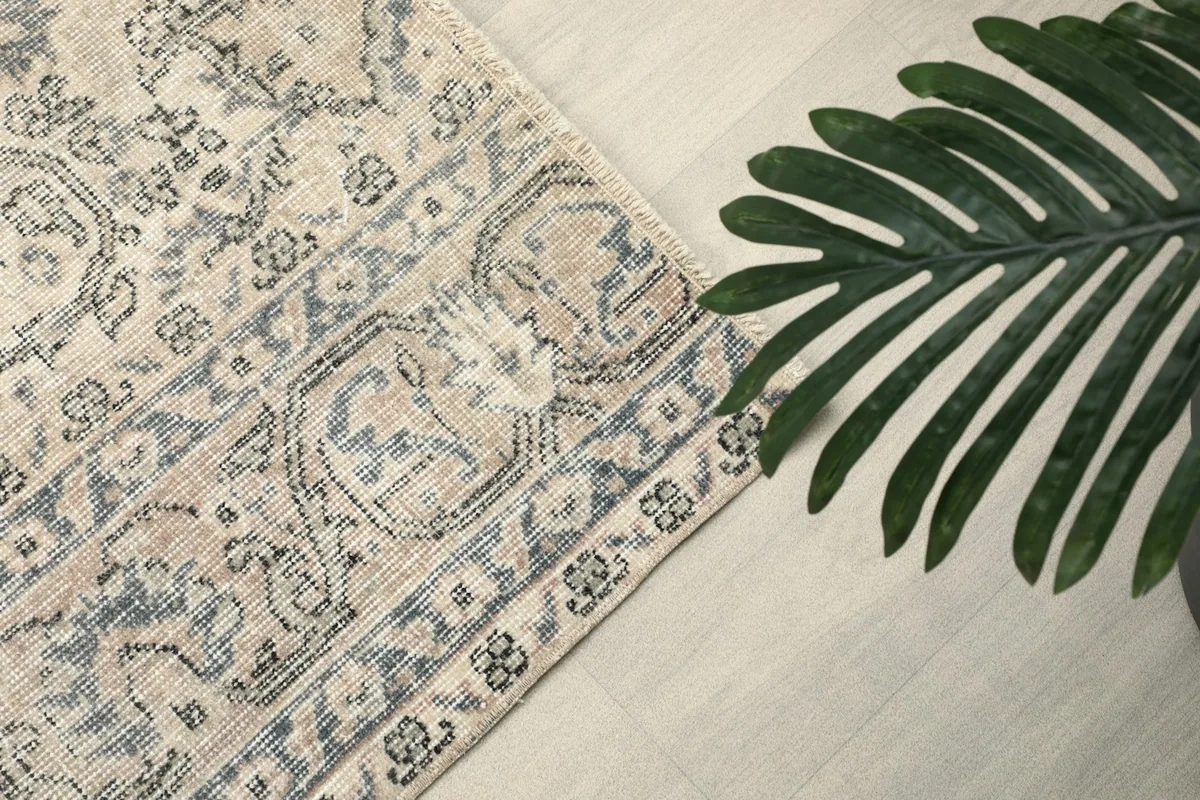 Detailed view of the ivory border with blue and gray geometric and floral elements