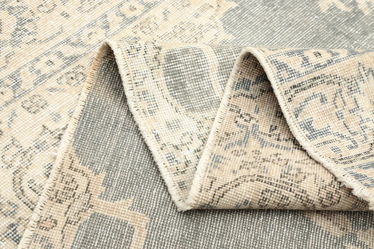 Side view of a folded rug section, showing the thickness and construction