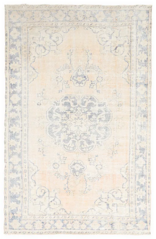 Full overhead view of the beige and blue vintage Anatolian rug with a central medallion