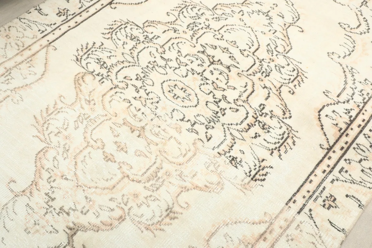 Detailed shot of the rug's patterns, showing the texture and the subtle color shifts in the pile