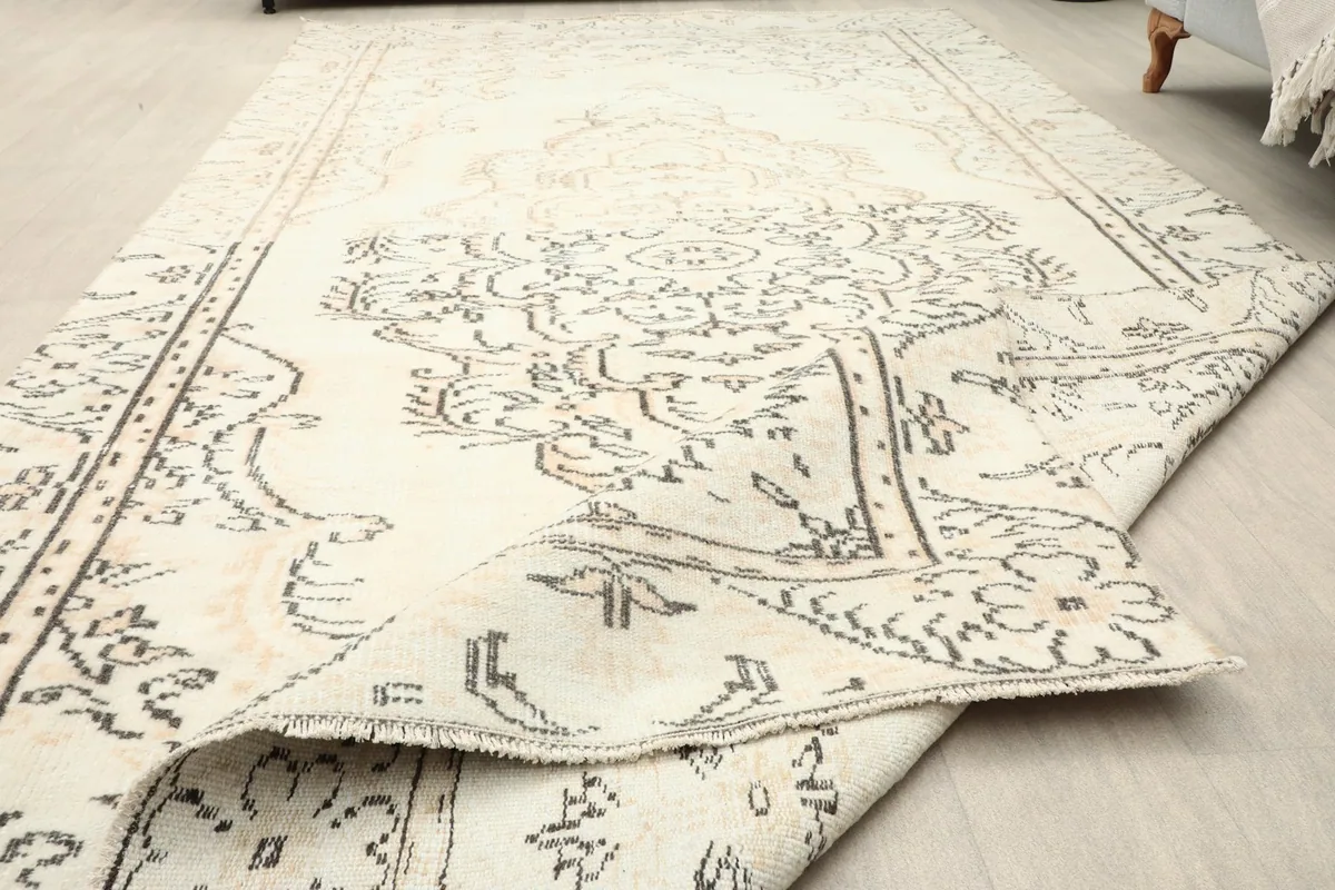Angle view showing the low pile height and the overall texture of the vintage wool rug