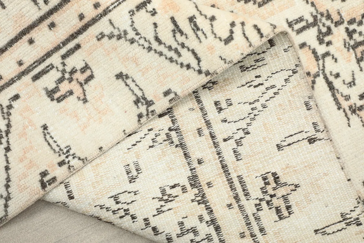 Close-up of the rug's cotton foundation and the back of the hand-knotted wool pile